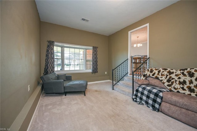 living area featuring carpet flooring and an inviting chandelier