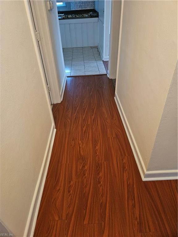 hallway featuring dark hardwood / wood-style flooring