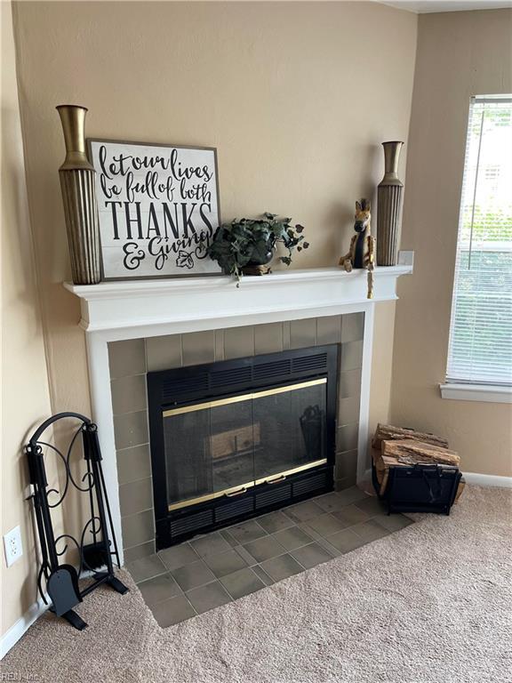 details featuring carpet floors and a tile fireplace