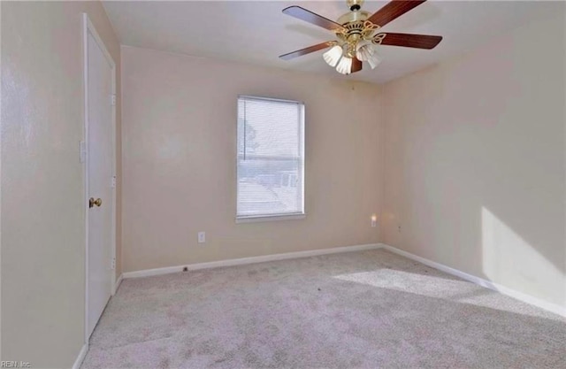 unfurnished room featuring light colored carpet and ceiling fan