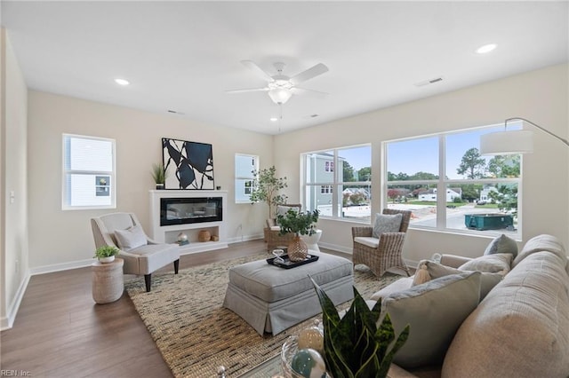 living room featuring hardwood / wood-style floors, plenty of natural light, and ceiling fan