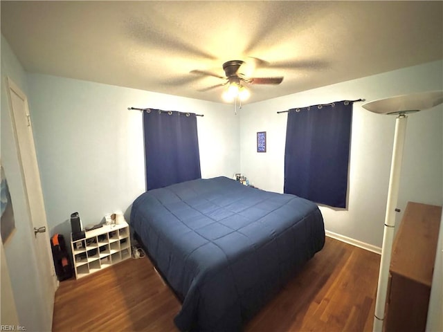 bedroom with dark wood-type flooring and ceiling fan