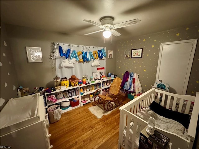 bedroom with ceiling fan and wood-type flooring