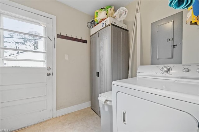 washroom featuring electric panel, washer / dryer, and light tile patterned floors