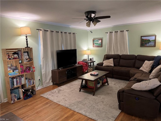 living room with ceiling fan, ornamental molding, and wood-type flooring