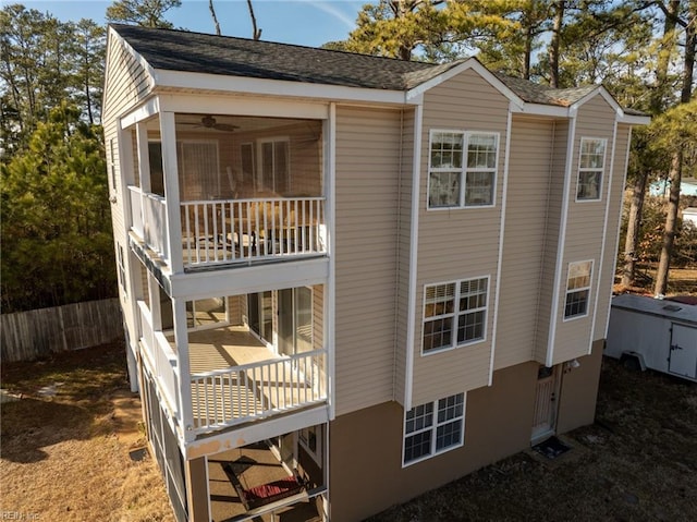 exterior space with ceiling fan and a balcony