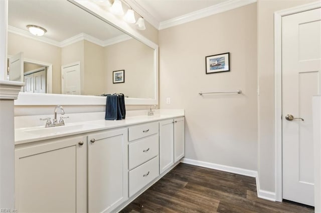 bathroom featuring hardwood / wood-style flooring, crown molding, and vanity