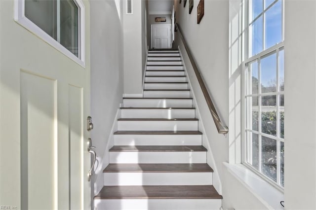 stairway featuring a high ceiling