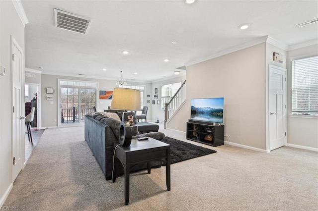 carpeted living room with plenty of natural light and ornamental molding