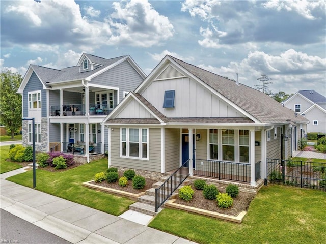 craftsman-style home with a front lawn, a balcony, and covered porch