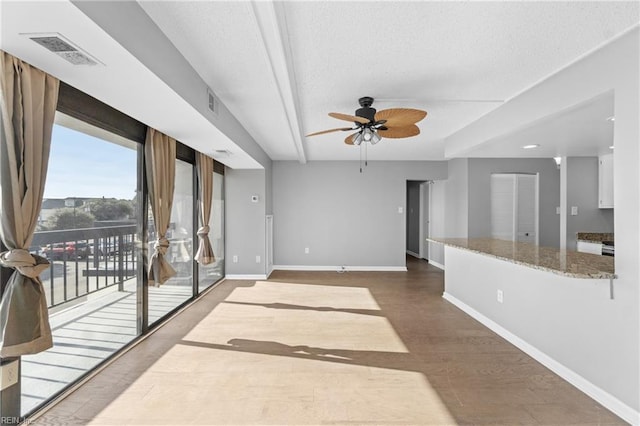 living room with hardwood / wood-style flooring, a textured ceiling, and ceiling fan