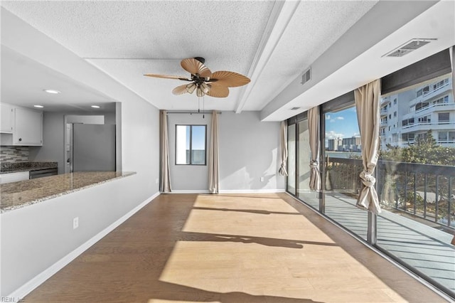 unfurnished room featuring hardwood / wood-style floors, a textured ceiling, and ceiling fan