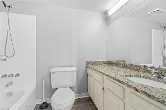 full bathroom with hardwood / wood-style flooring, vanity, toilet, and tiled shower / bath combo