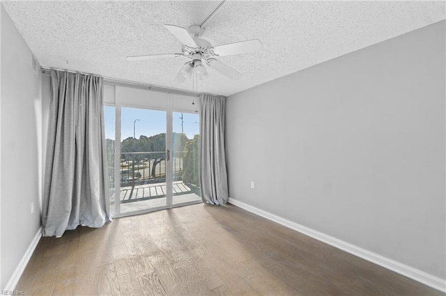 spare room featuring ceiling fan, hardwood / wood-style floors, and a textured ceiling