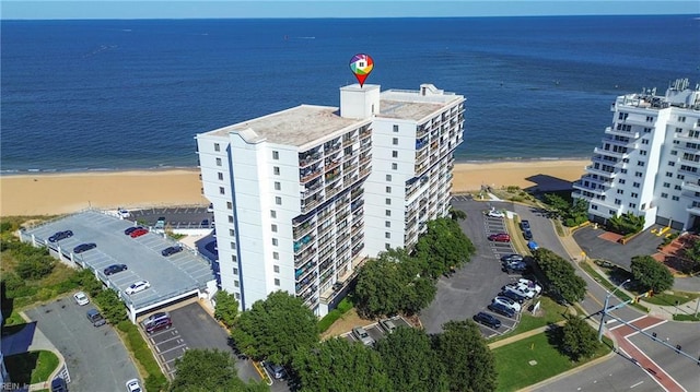 drone / aerial view with a water view and a beach view