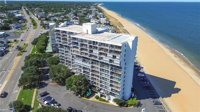 birds eye view of property featuring a water view and a view of the beach