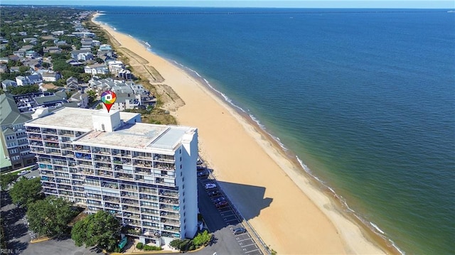 drone / aerial view with a beach view and a water view