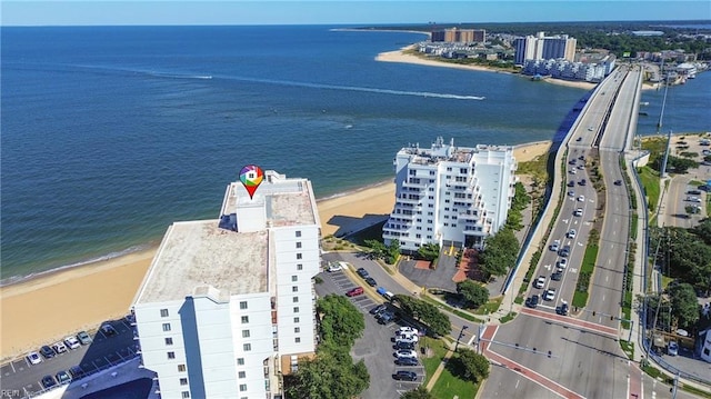 drone / aerial view with a water view and a beach view