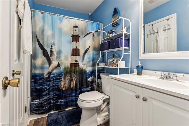 bathroom with vanity, hardwood / wood-style floors, a shower with shower curtain, and toilet