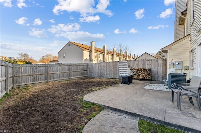 view of yard featuring central AC unit and a patio area