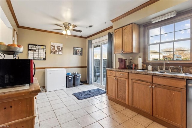 kitchen featuring refrigerator, dishwasher, sink, ornamental molding, and light tile patterned floors