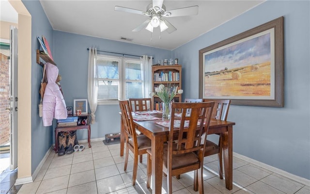 tiled dining room with ceiling fan