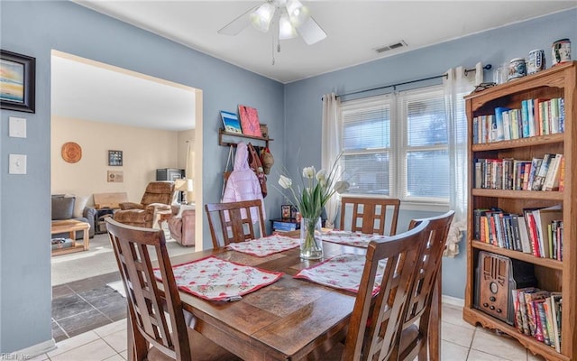 tiled dining room featuring ceiling fan