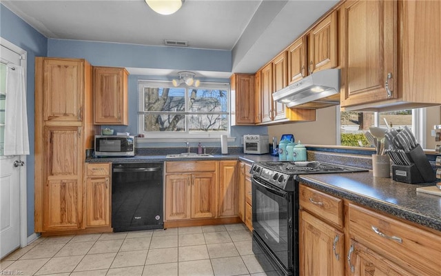 kitchen featuring light tile patterned floors, sink, and black appliances