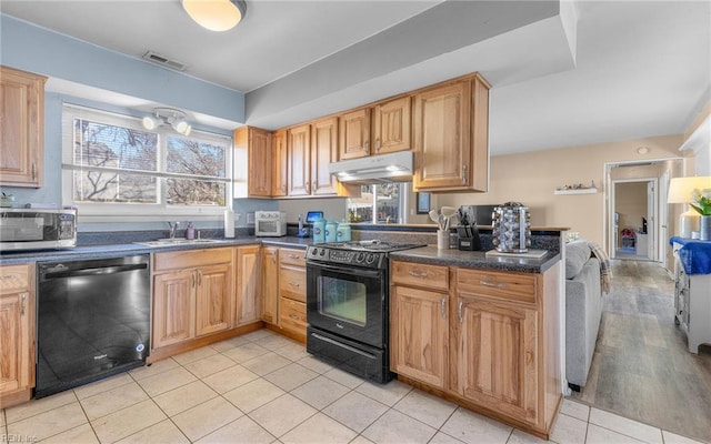 kitchen featuring light tile patterned flooring, kitchen peninsula, sink, and black appliances