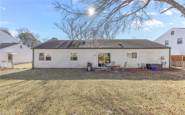 back of house with a yard and a patio area