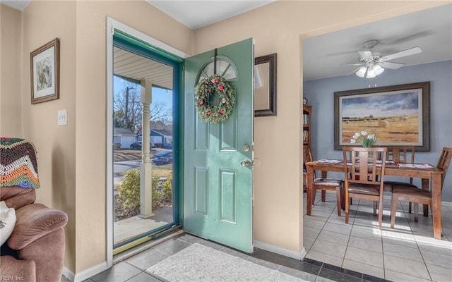 entrance foyer featuring light tile patterned floors and ceiling fan