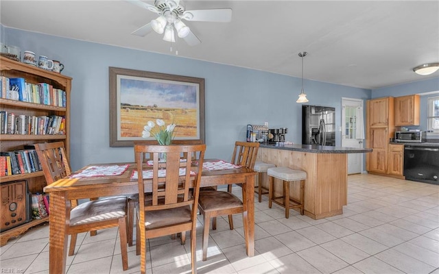 dining area featuring light tile patterned floors and ceiling fan