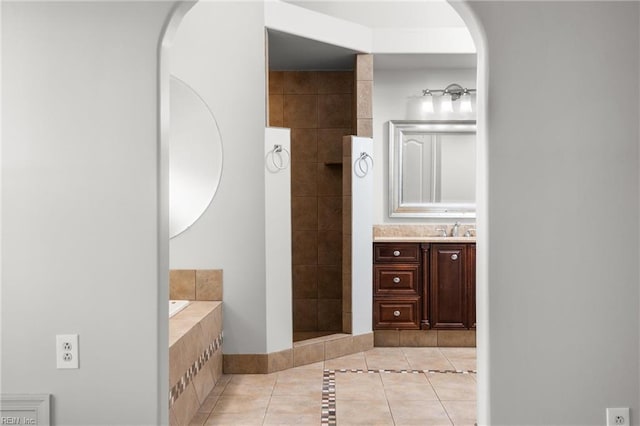 bathroom featuring vanity, tile patterned floors, and tiled shower