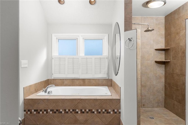 bathroom with tile patterned floors and independent shower and bath