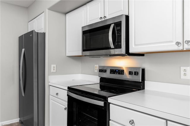 kitchen with white cabinetry and appliances with stainless steel finishes