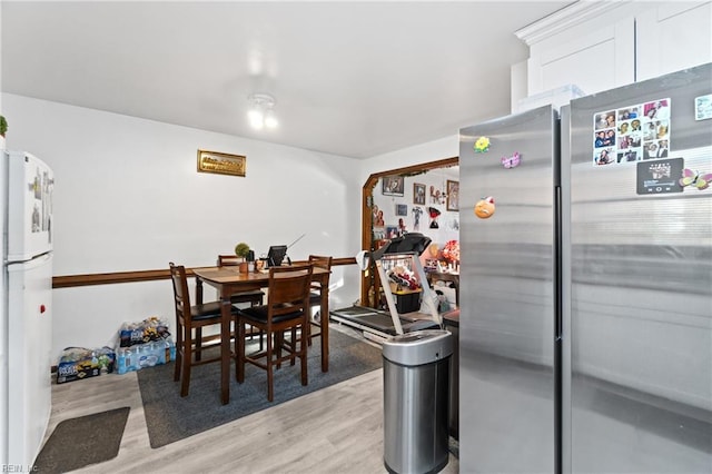 dining area with light hardwood / wood-style floors