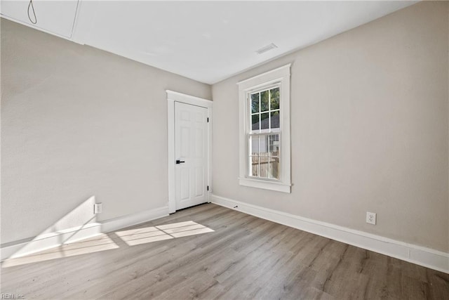 empty room with hardwood / wood-style flooring