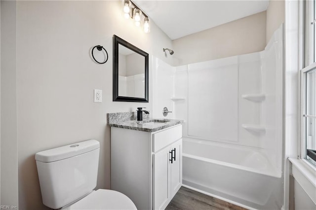 full bathroom featuring hardwood / wood-style flooring, vanity,  shower combination, and toilet