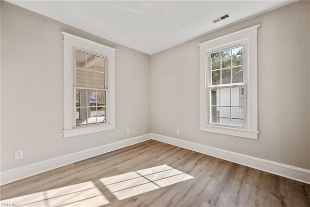 spare room featuring light wood-type flooring