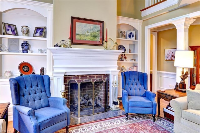 living area featuring a brick fireplace and built in features