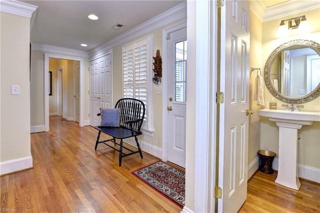 hallway featuring hardwood / wood-style flooring and ornamental molding