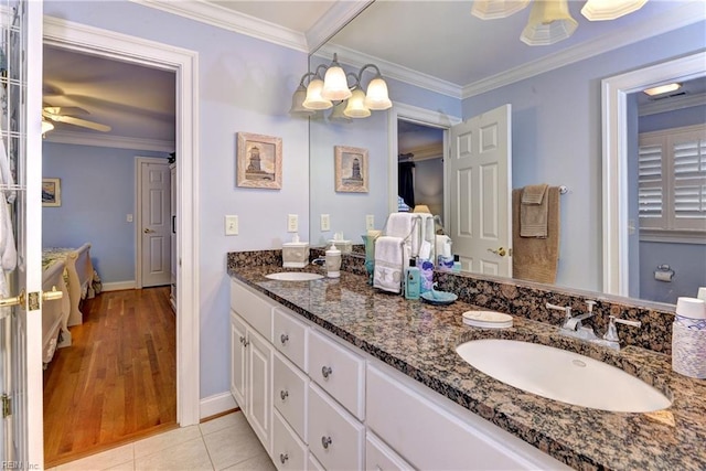 bathroom featuring vanity, tile patterned floors, ceiling fan with notable chandelier, and ornamental molding