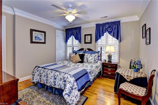 bedroom featuring crown molding, ceiling fan, and light hardwood / wood-style floors