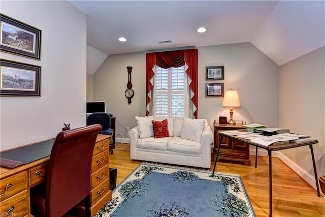 office featuring lofted ceiling and light hardwood / wood-style floors