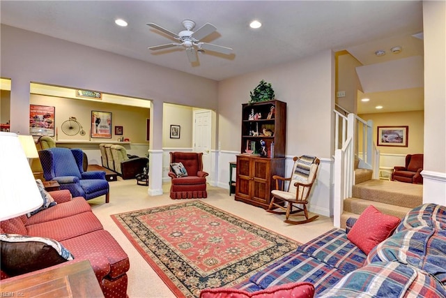 carpeted living room featuring ceiling fan and ornate columns