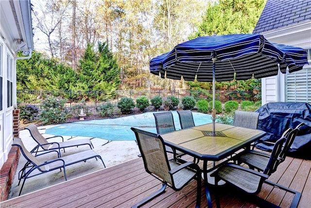 wooden terrace with a fenced in pool