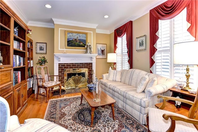 living room featuring crown molding, a brick fireplace, and light hardwood / wood-style floors