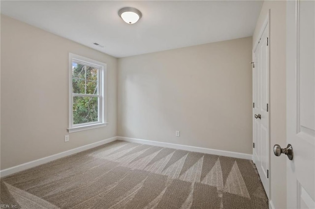 unfurnished bedroom featuring carpet floors, visible vents, and baseboards