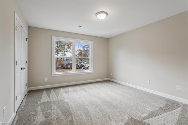 unfurnished bedroom featuring carpet flooring, visible vents, and baseboards