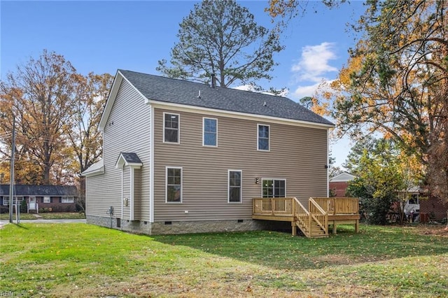 back of property with crawl space, roof with shingles, a yard, and a deck